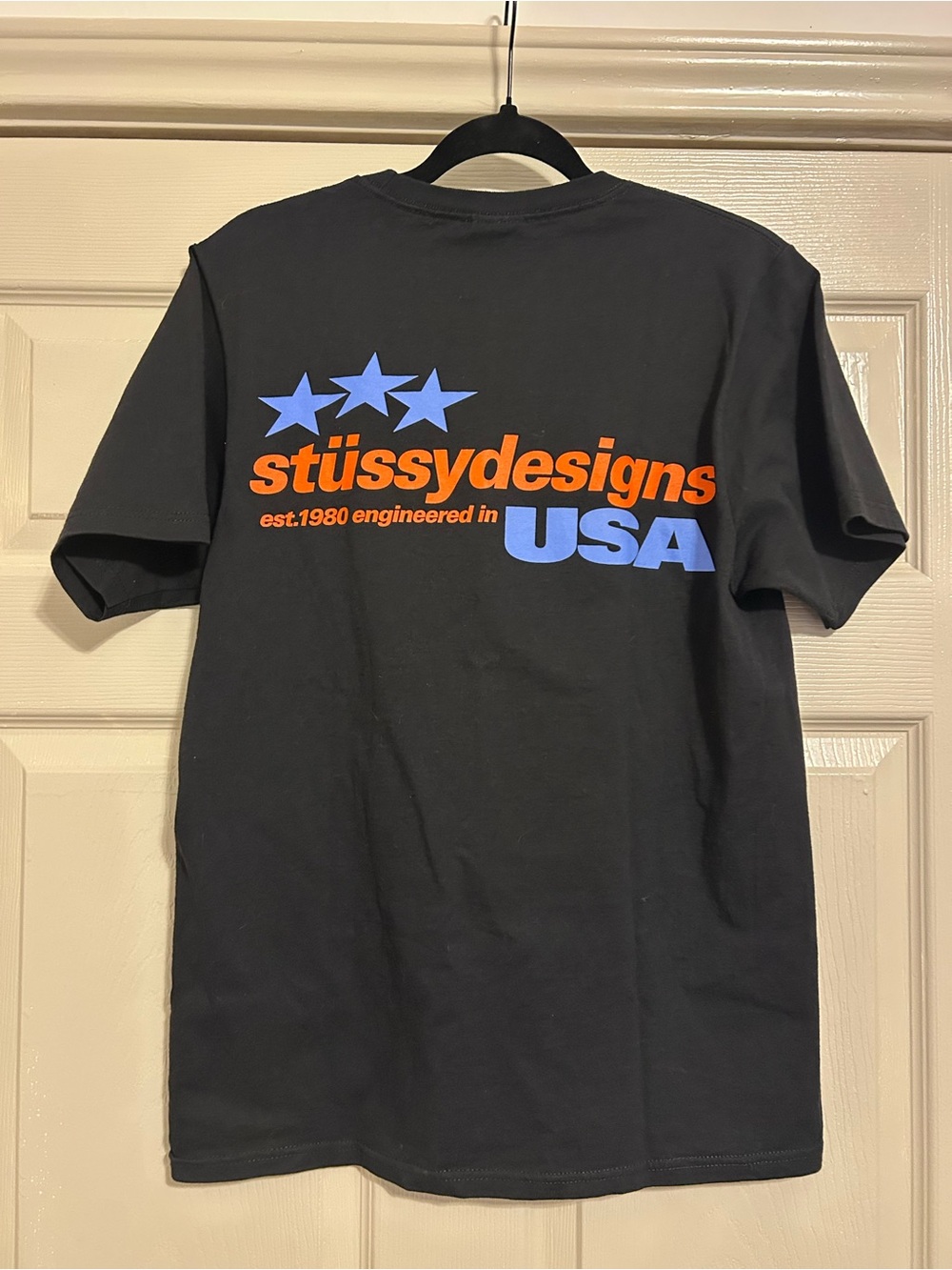 Stussy Designs USA Logo Back Graphic T-Shirt - Black/Blue/Orange